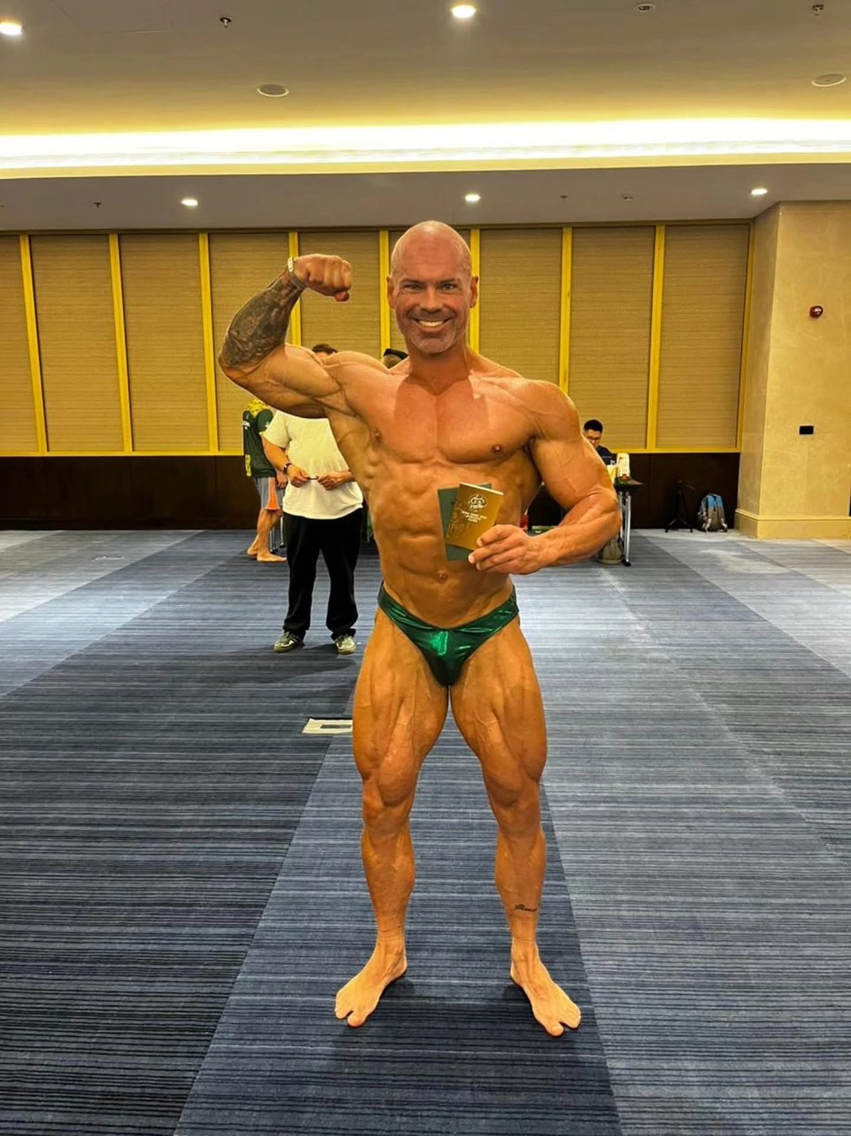 Steven Domeris at a bodybuilding competition holding his medal